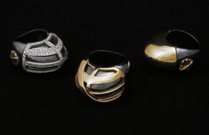 Three unique designer rings featuring gold and silver tones, showcasing intricate designs and sparkling embellishments.