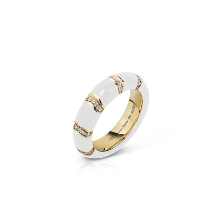 White band ring with gold accents and small diamonds set in a pattern.