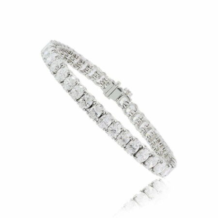 Oval tennis bracelet featuring clear stones set in a silver-tone metal band, showcasing a classic and elegant design.