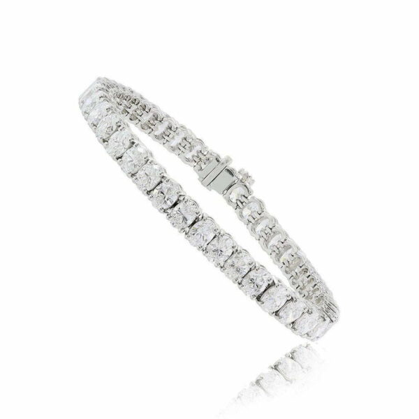 Oval tennis bracelet featuring clear stones set in a silver-tone metal band, showcasing a classic and elegant design.