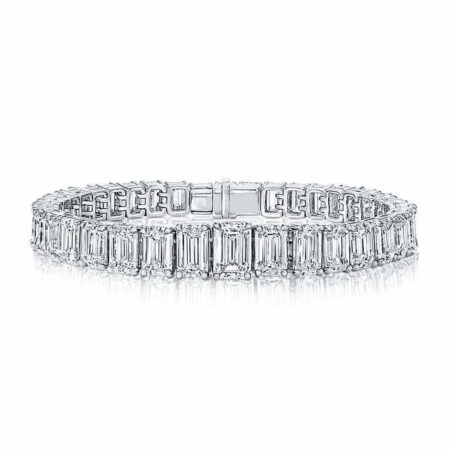 Elegant emerald cut diamond bracelet featuring a series of sparkling diamonds set in a white gold band, showcasing luxury and sophistication.