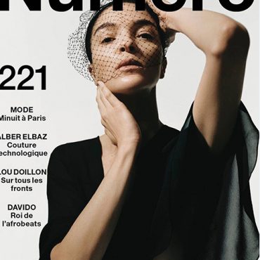 Cover of Numéro Magazine issue 221 featuring a model with a veil and black attire, highlighting fashion and style.