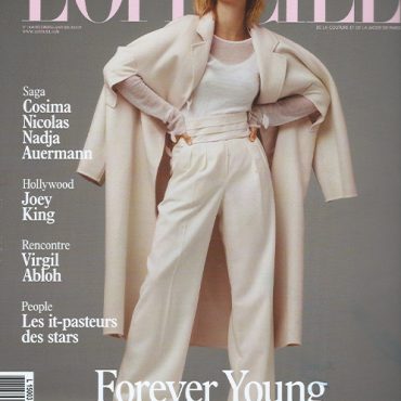 L'Officiel magazine cover featuring Hailey Baldwin in a stylish outfit, showcasing fashion and contemporary trends.