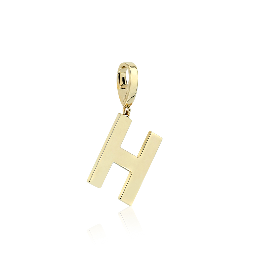 Gold charm in the shape of the letter H with a polished finish and a loop for attachment.