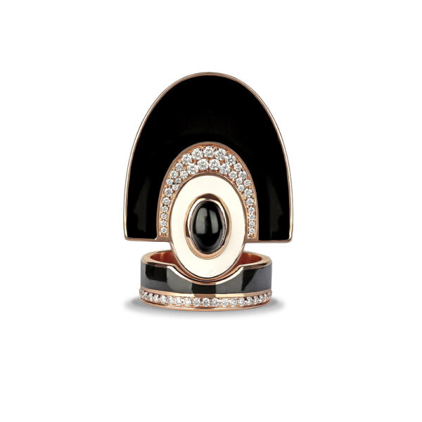 A stylish black and gold statement ring featuring a large oval gemstone and intricate diamond accents, perfect for fashion enthusiasts.