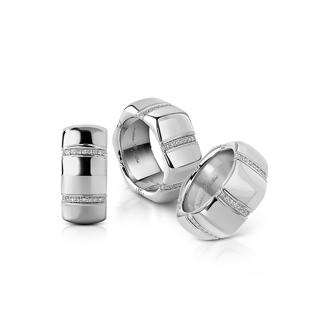 Three silver rings featuring smooth surfaces and diamond accents arranged together.