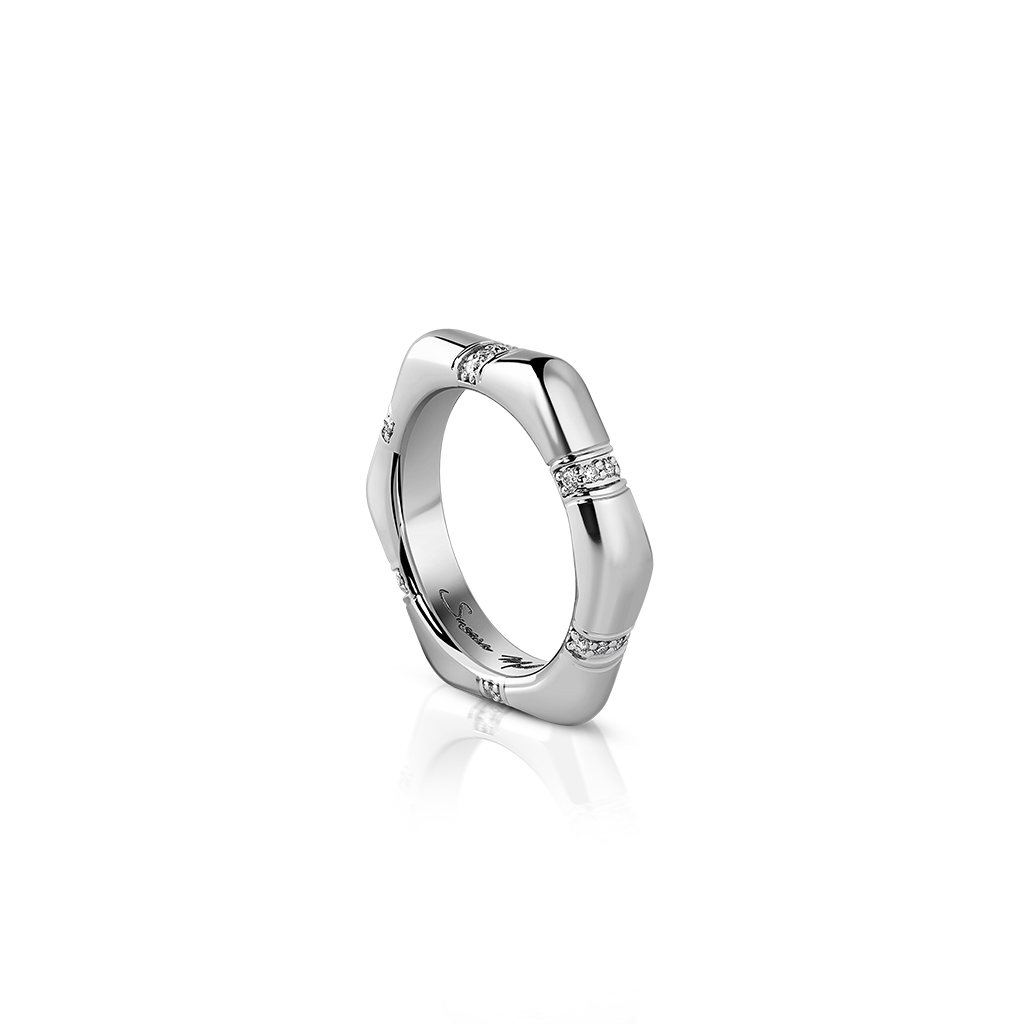 Silver geometric ring featuring diamond accents on a white background.