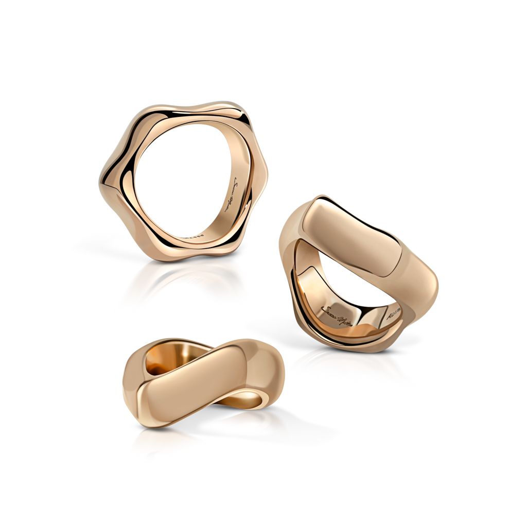 Three gold rings featuring unique shapes and finishes displayed together on a white background.