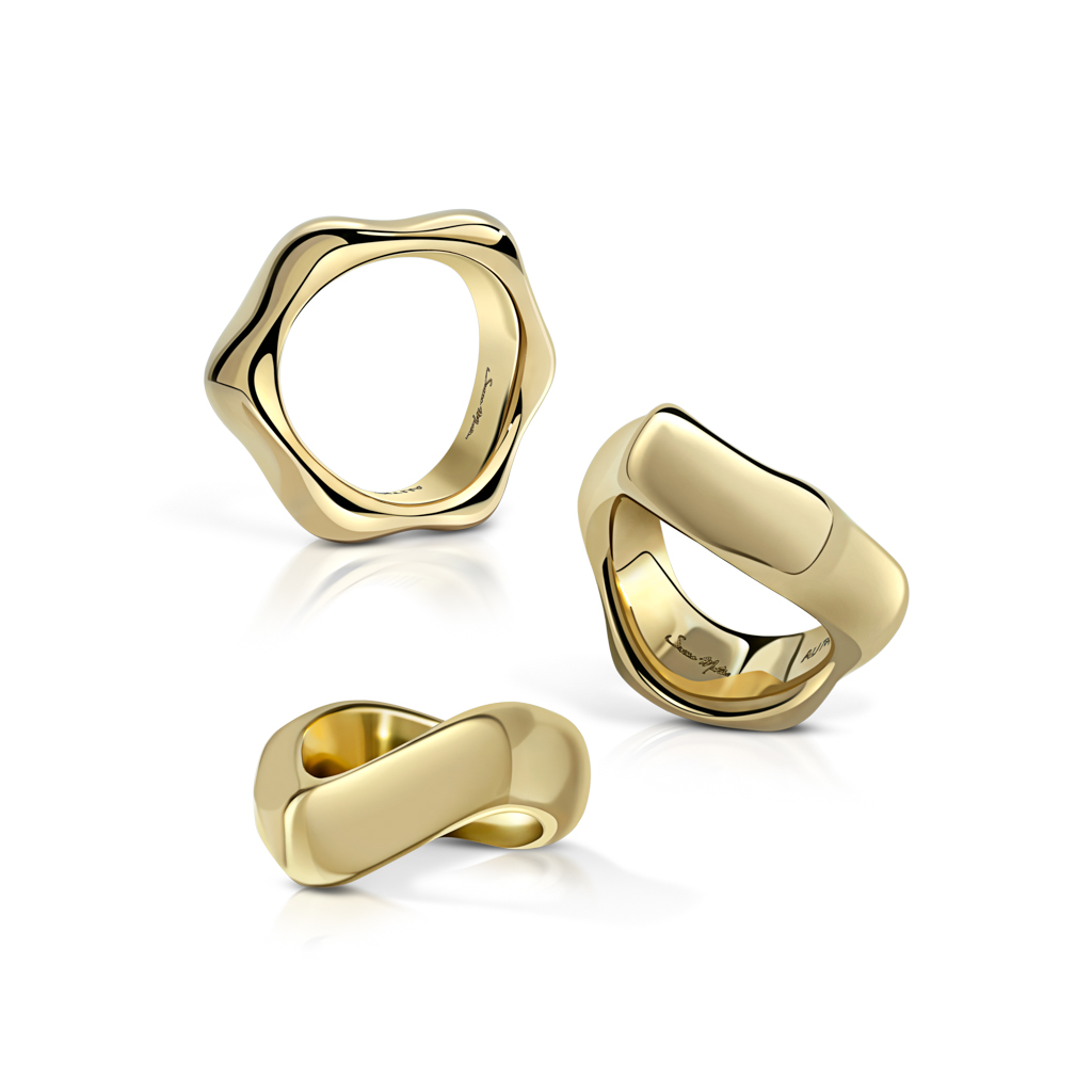 Three gold rings with unique designs displayed together on a white background.