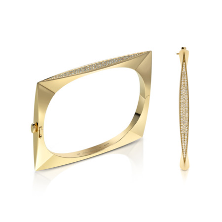 Gold bangle with a geometric design and diamond accents on one side.