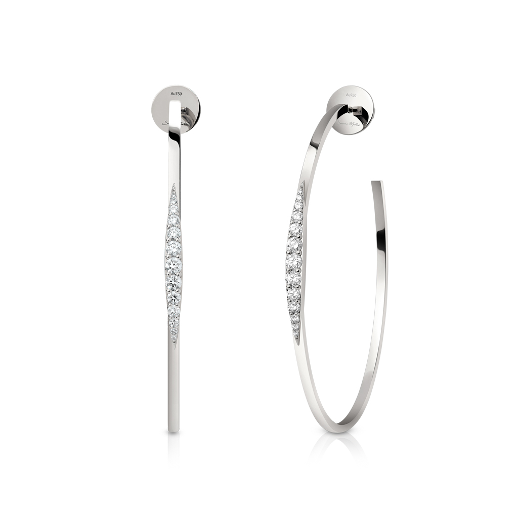 Silver hoop earrings featuring diamond accents along one side in a sleek design.