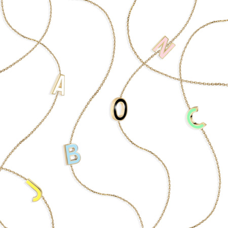 Colorful enamel letter charms on a gold chain necklace, featuring letters A, B, C, J, N, and O, designed by Susana Martins.
