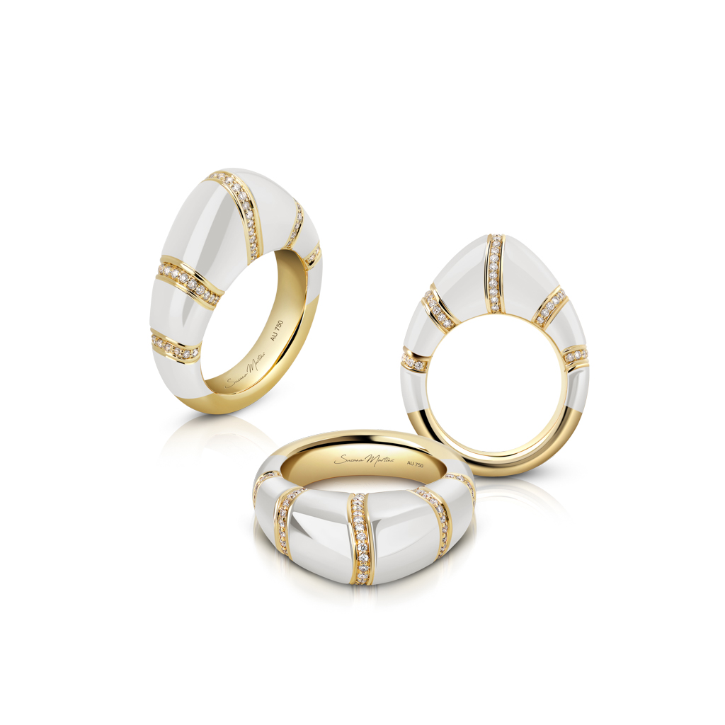 Three dome rings featuring white enamel and gold accents, with one ring set with small diamonds.