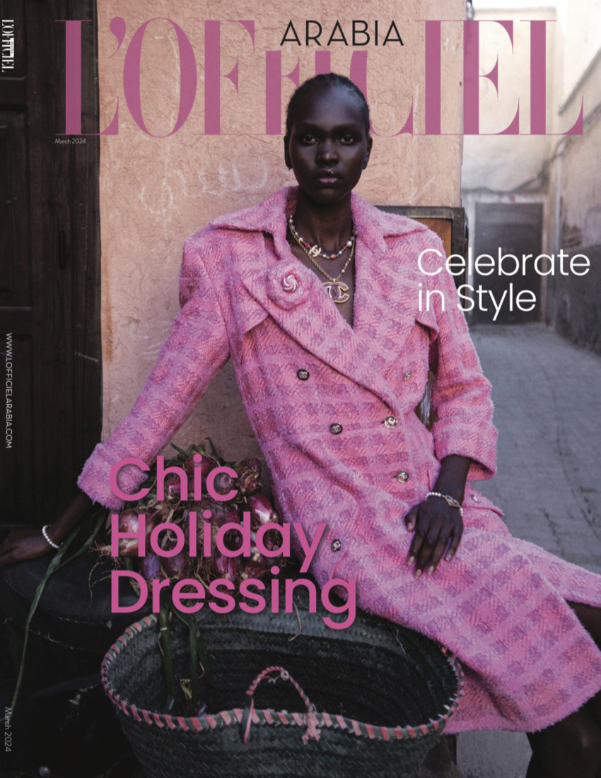 L'Officiel Arabia magazine cover featuring a model in a pink coat, showcasing chic holiday dressing for March 2024.