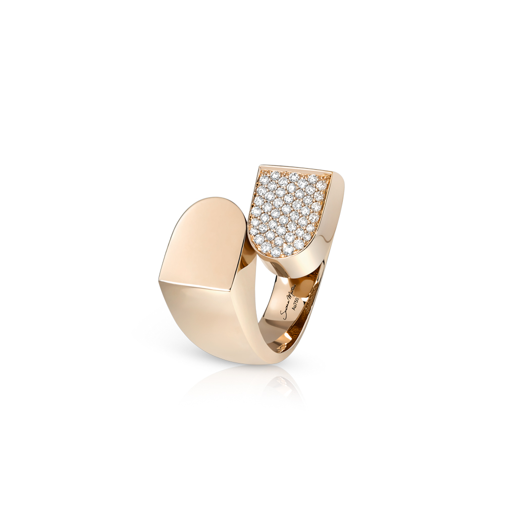 Gold ring with a smooth band and a diamond-encrusted top section in a unique design.