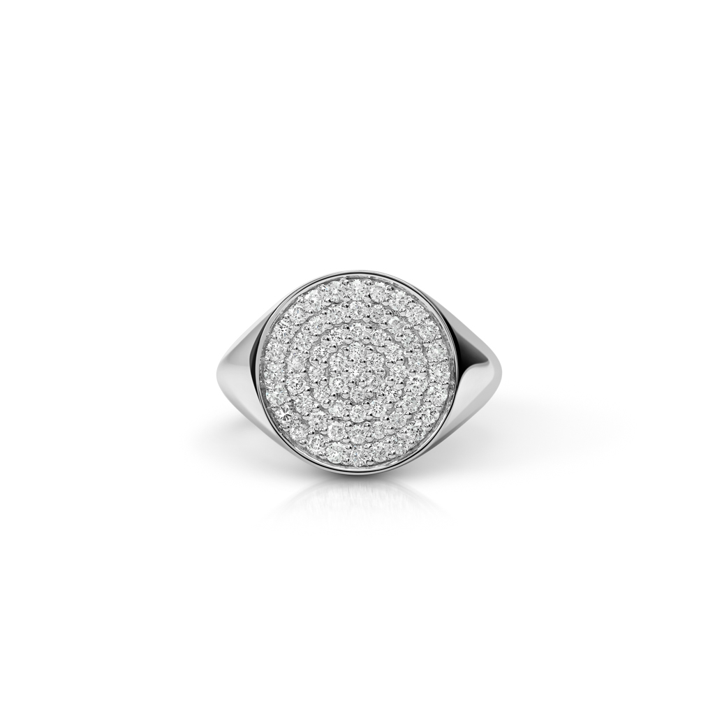 Round signet ring featuring a paved design of small diamonds on a polished silver band.