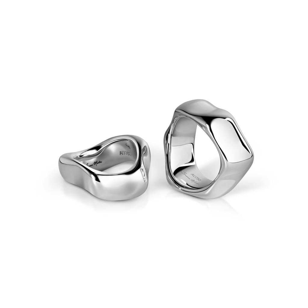 Two white gold rings with a smooth, organic shape displayed from different angles.