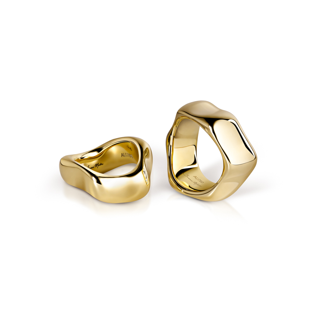 Two yellow gold rings with an organic, smooth design displayed together.