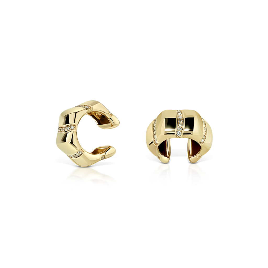 Gold ear cuffs featuring diamond accents in a modern design.