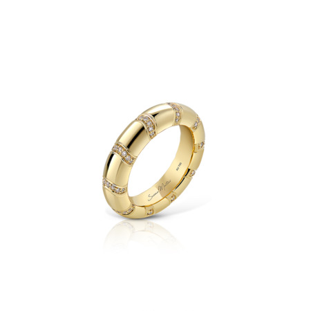 Gold band ring featuring diamond accents arranged in a pattern around the band.