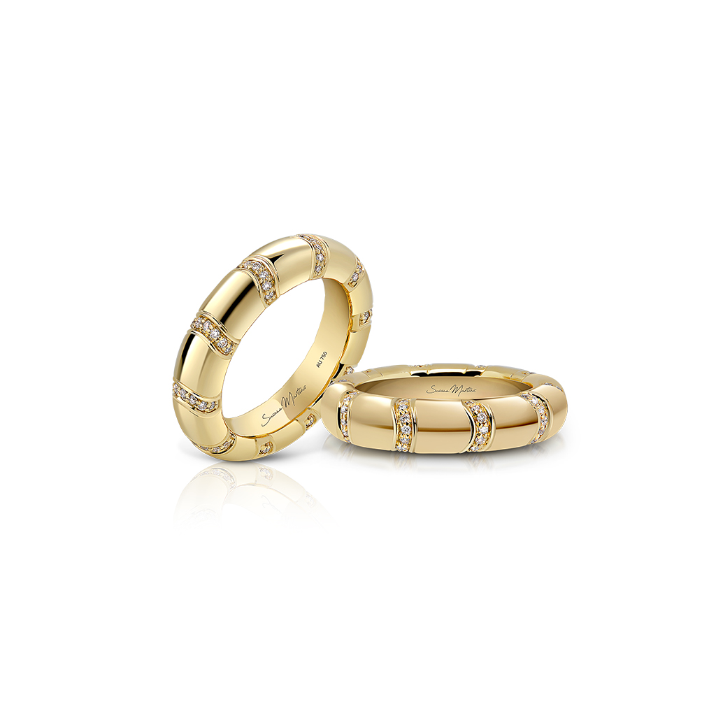 Two gold stackable rings with diamond accents displayed on a white background.