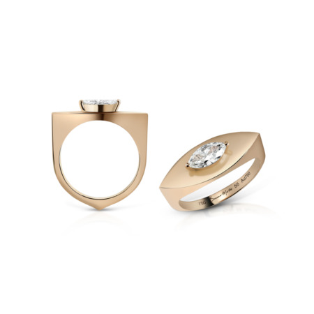 Gold ring featuring a marquise cut diamond set in a modern design with a unique shape.