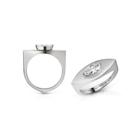 Silver ring featuring a marquise cut diamond set on a smooth band with a unique design.