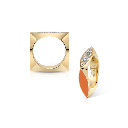Two gold stackable rings, one with orange enamel and the other with clear stones, displayed on a white background.