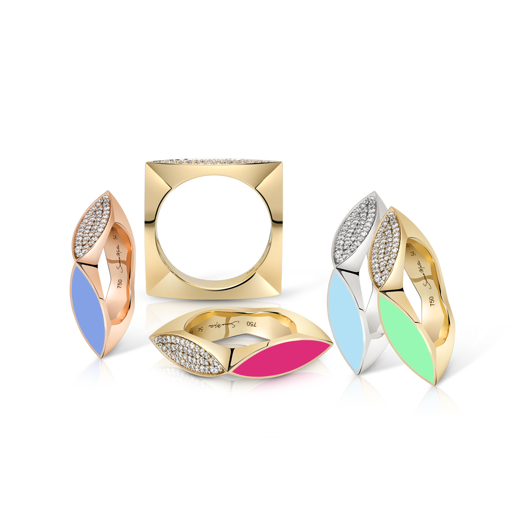 Collection of stackable rings featuring enamel and metal designs in various colors and shapes.