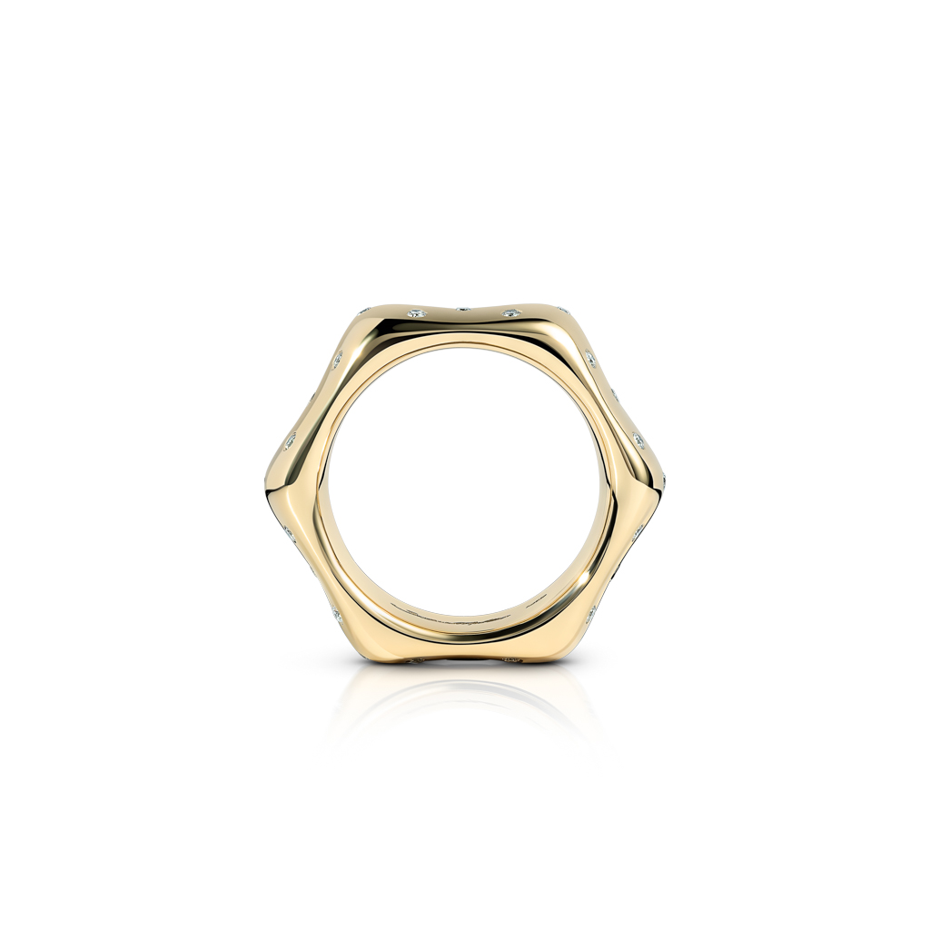 Gold ring with a polka dot design, featuring a unique hexagonal shape and small embellishments.