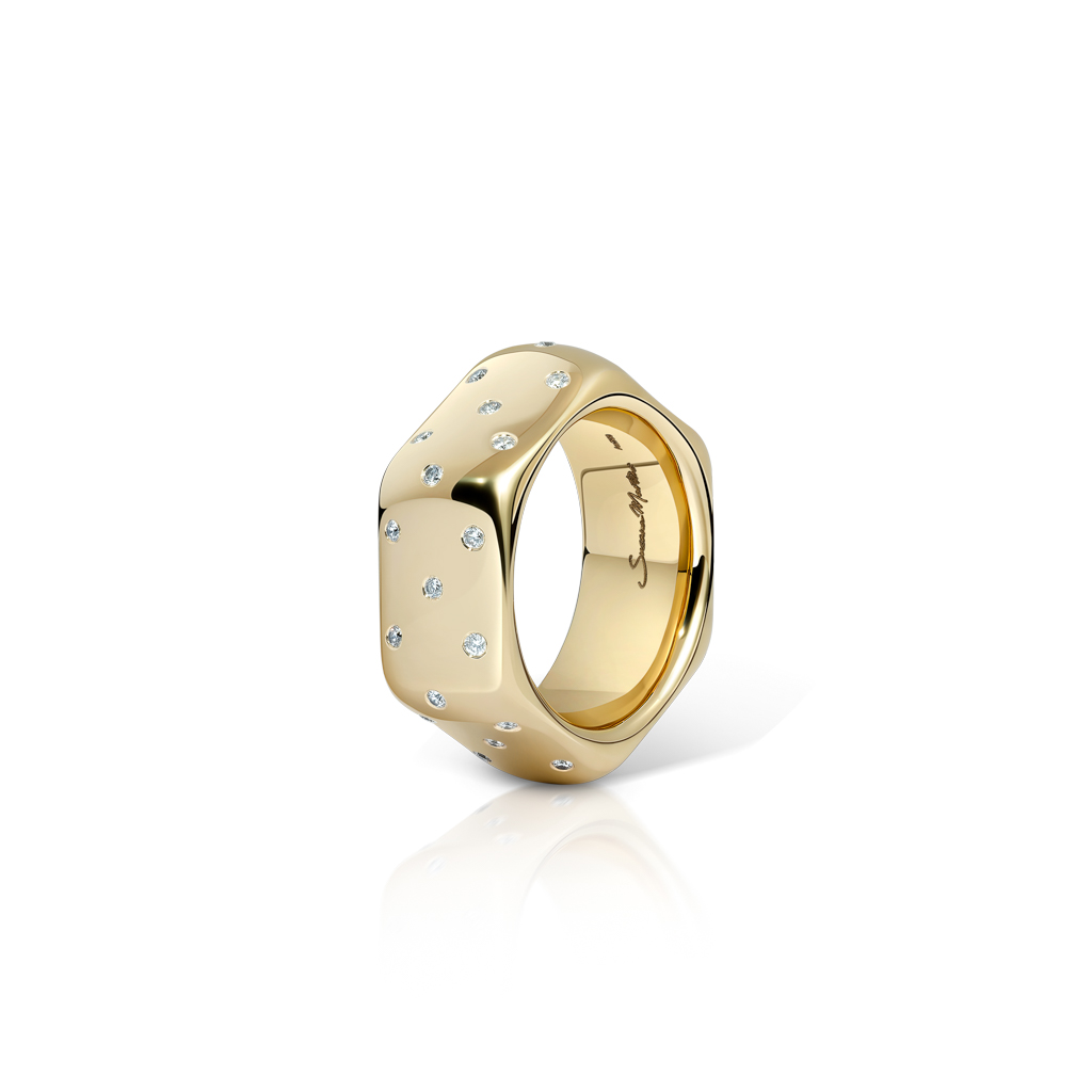 Yellow gold ring with polka dot design and small embedded diamonds.